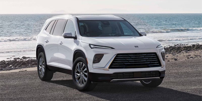 White Buick Enclave SUV parked by the ocean