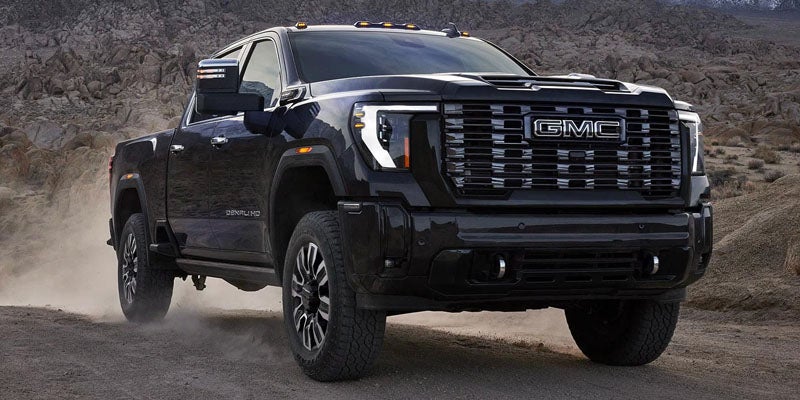 GMC Sierra 2500 HD driving on a rugged dirt road