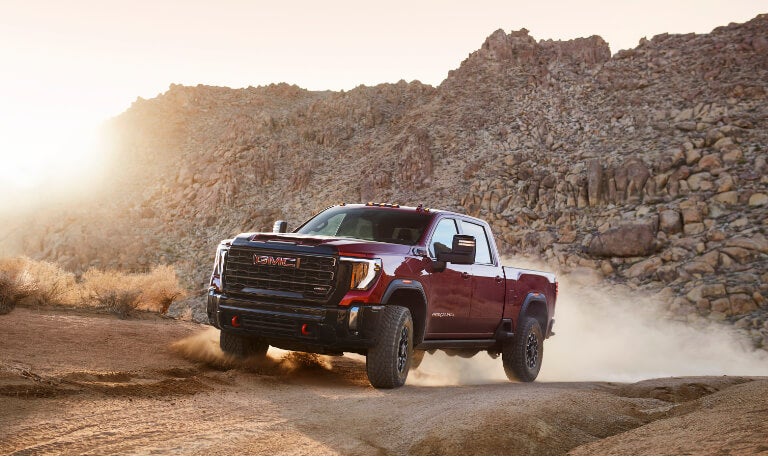 2024 GMC Sierra 2500 driving on dusty road